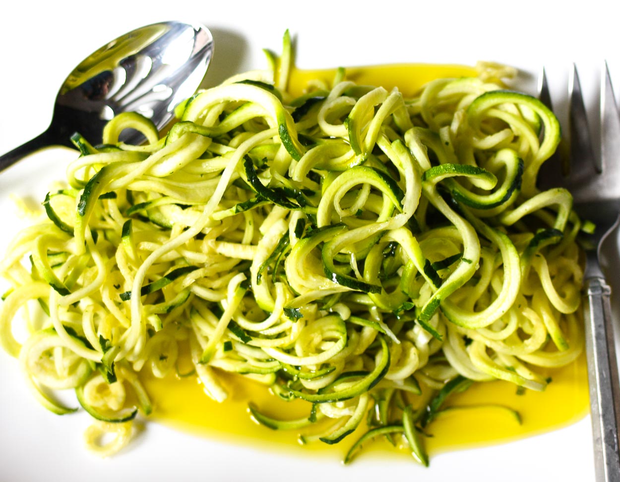 raw zucchini noodles with pesto and tomatoes