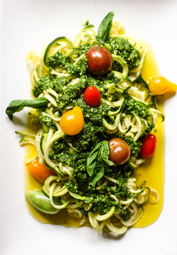 raw zucchini noodles with pesto and tomatoes